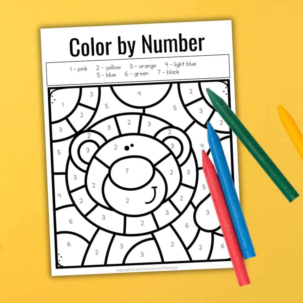 Lion color by number worksheet with colored crayons