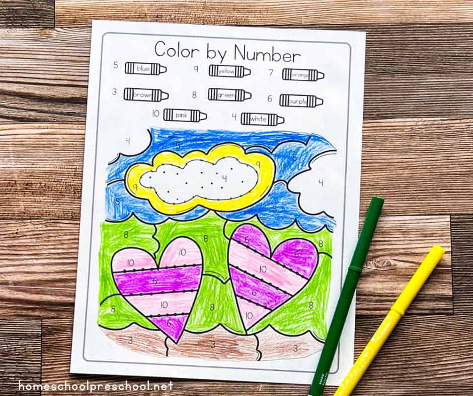 heart color by number on a wooden background. green marker. yellow marker.
