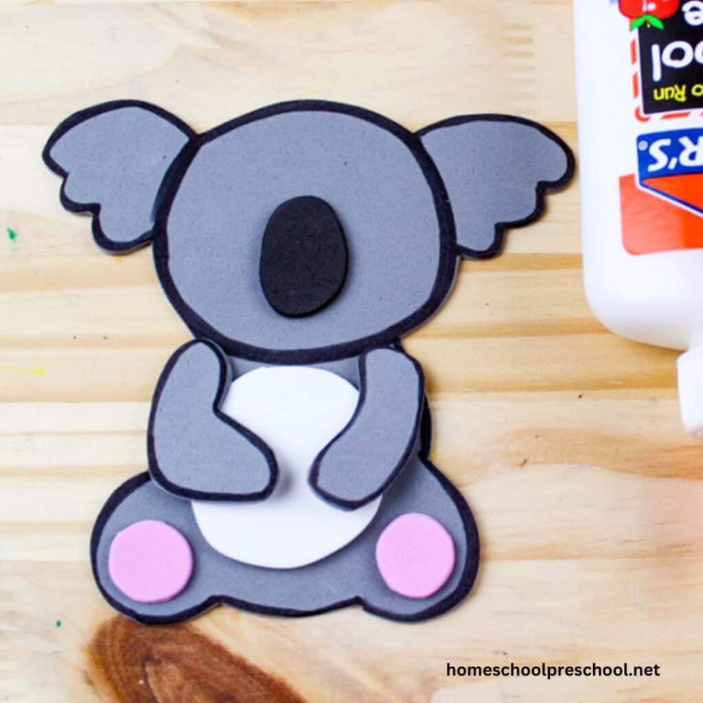 pieces of koala craft and elmer's glue on plywood background