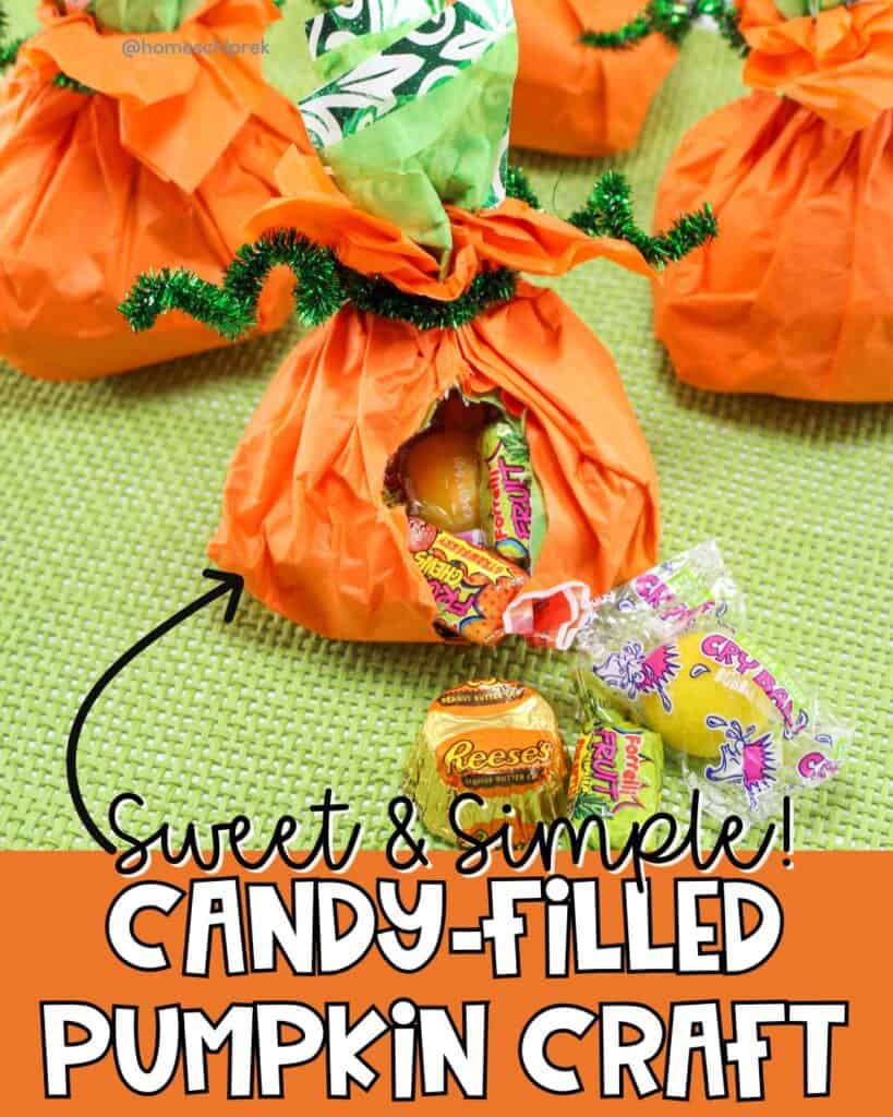 Candy-stuffed pumpkins craft made with orange tissue paper, green pipe cleaners, and filled with assorted Halloween candy, displayed on a green mat.