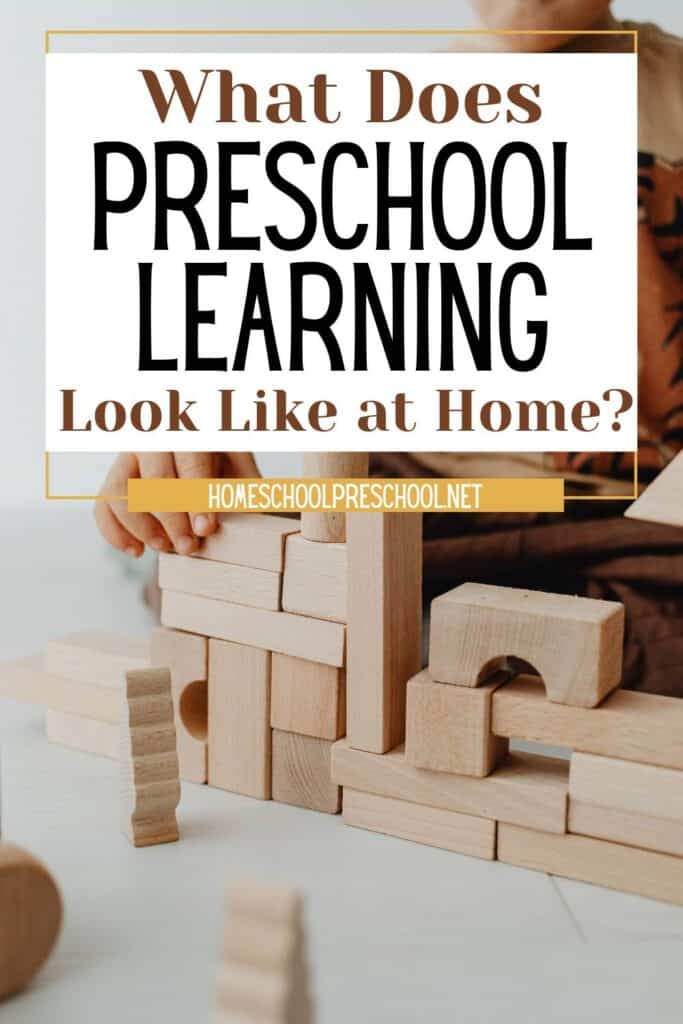 Child building with wooden blocks at home. Text reads "What does preschool learning look like at home?" Homeschool preschool resource showing play-based learning.
